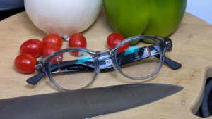 closeup-of-solos-airgo-a5-smart-glasses-resting-on-cutting-board-with-knife-and-vegetables.jpg